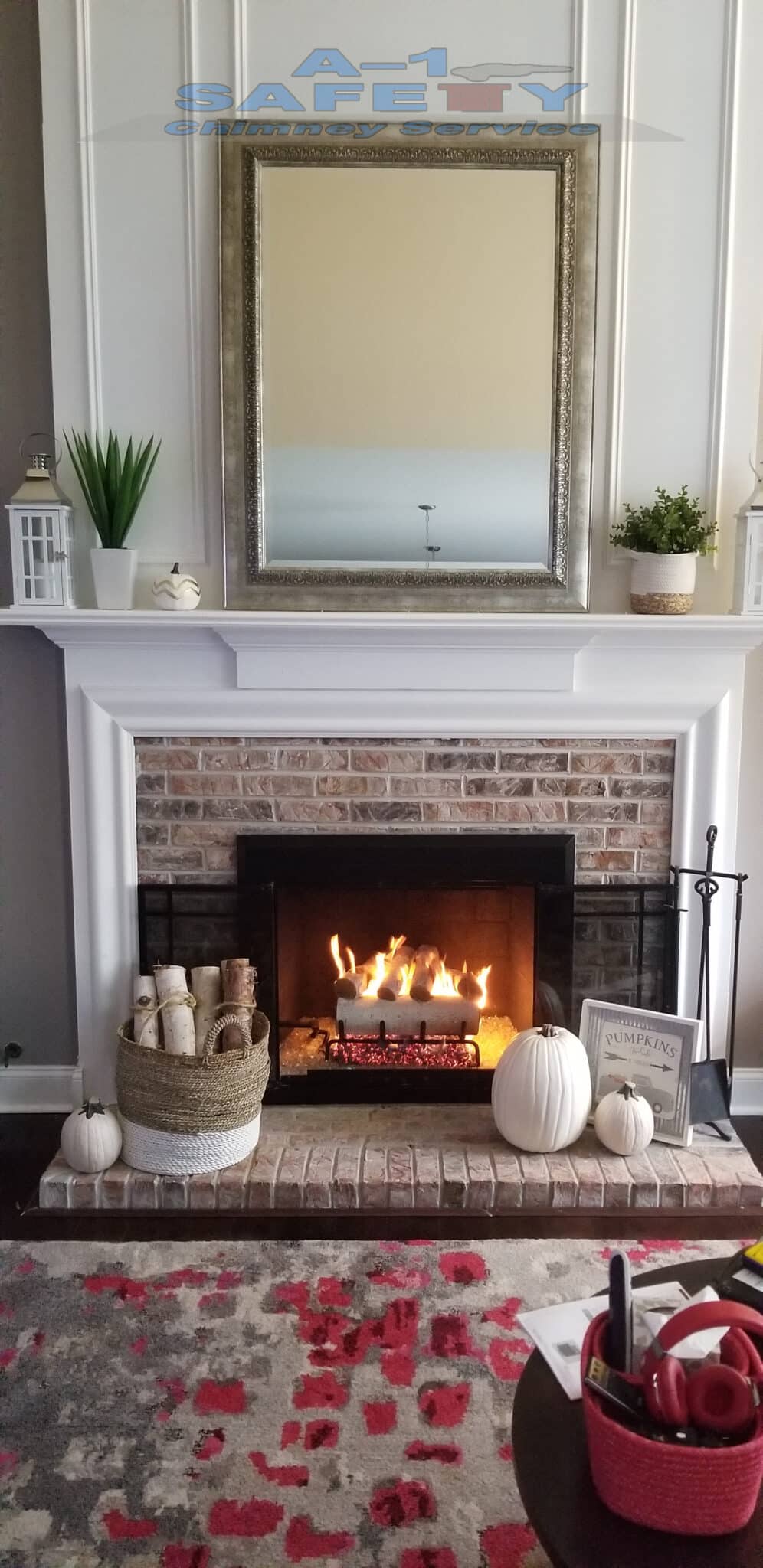 Fireplace with burning logs and pumpkins.